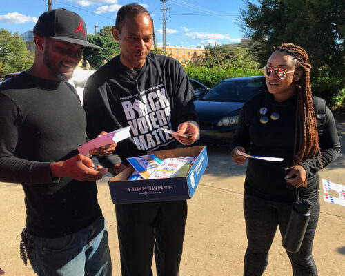 Volunteers for Black Voters Matter hand out flyers