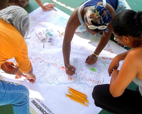 three women marking a map