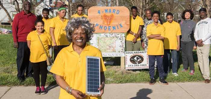 4 Ward Phoenix group - woman with small solar panel