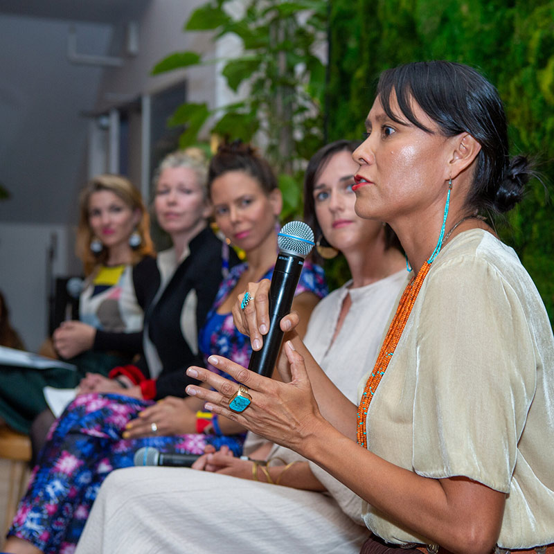 Co-founder and former CEO of Native Renewables Wahleah Johns speaking with panel of women