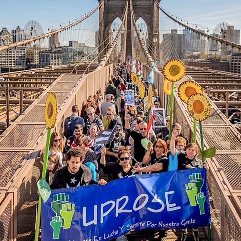 UPROSE marching across bridge