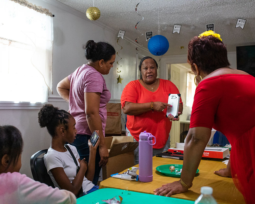 Ms. Sylvia and Ms. Sonya of Louisiana League of Conscious Voters demonstrating the battery charger at a meeting