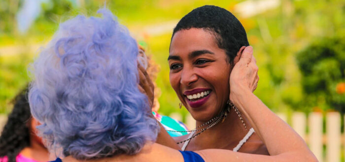 Two women greeting each other happily