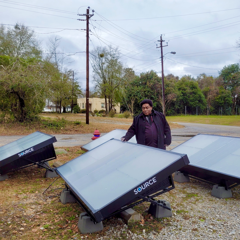 Man outside with four large solar panels