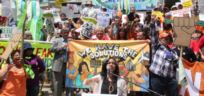 climate justice rally, many people holding signs