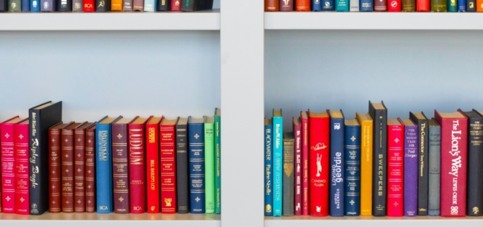 Colorful books on white bookshelf