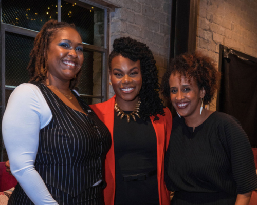 3 Black women all smiling with various heads of natural hair, all dressed in Black