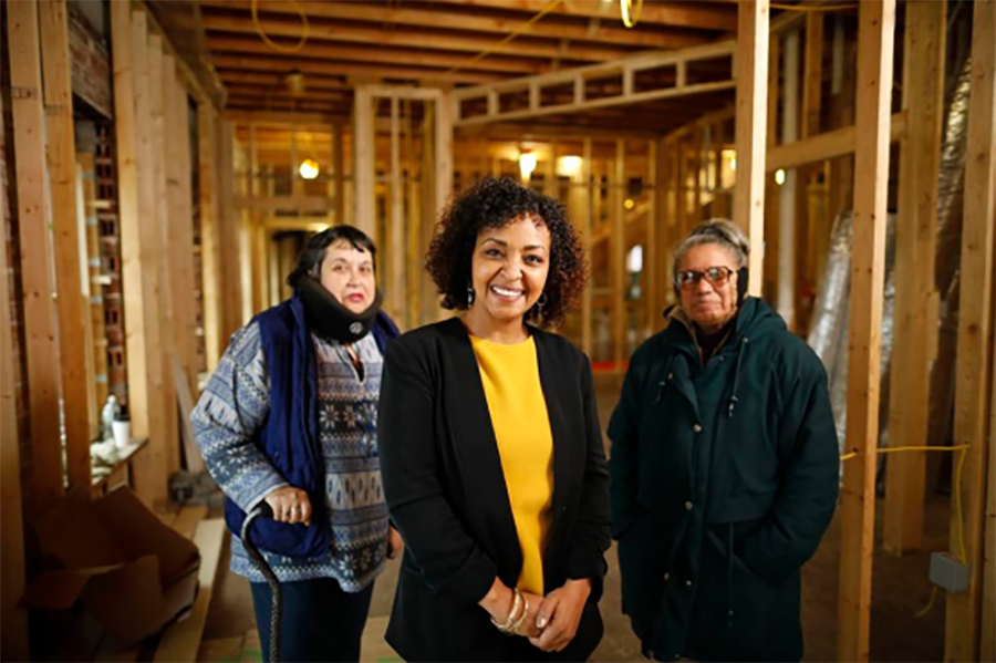 group of three people smiling on a new construction site